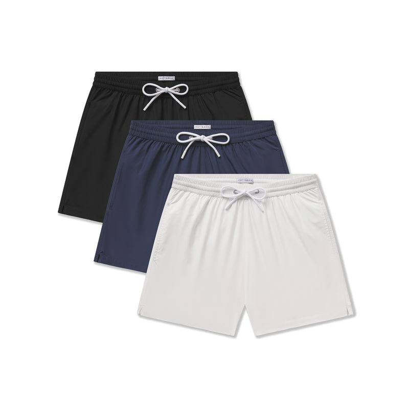  wearing White/Black/Navy The Swim Trunk 3-Pack